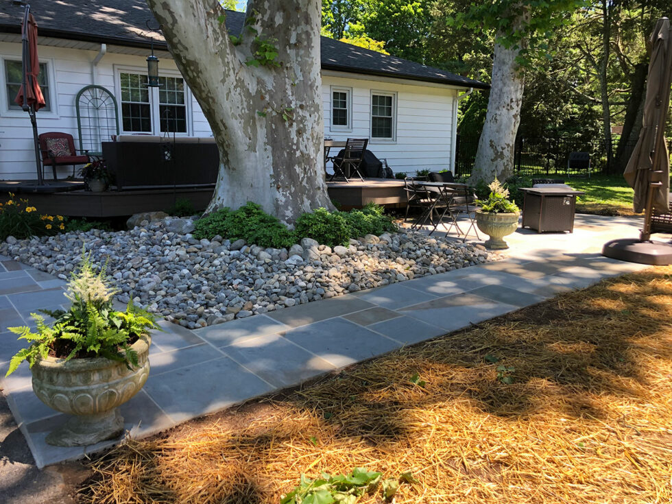 well-designed outdoor space featuring vibrant flowers, lush greenery, and expert hardscaping.